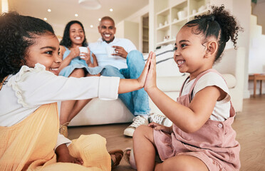 Family, high five and children playing, smile and having fun in a living room. Kids, hands and...