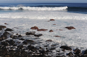 Fototapeta premium Waves breaking and crushing on the rocks on the Atlantic Ocean on coastline and seashore of Madeira Island , Portugal, Europe