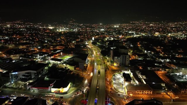The Zapote district in San Jos&eacute;, Costa Rica, at night. Slow rotating movement, aerial drone shot, showing the lights from the buildings and the roads.
