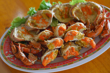 Close up Steamed crab's eggs delicious Thai seafood style or Boiled crab's spawn with spicy seafood dipping sauce. blue swimming sea crab.