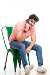 Young Indian man talking on smartphone.