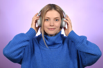 cute pretty blonde woman listening to music in headphones