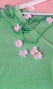 elegant green aquamarine sweater with pearls of the same color  and spring pibk flowers like beauty and accessories woman spring fashion 
