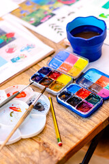 Watercolor Painting Workshop. Artist paint brushes on the wooden background