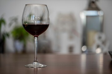 Glass of red wine on a wooden kitchen table