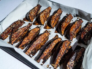 Cooked oven-roasted tasty eggplant wedges with miso sauce