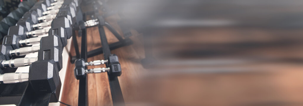 Metal dumbbells for strength training in gym.