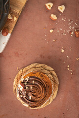Chocolate chip muffins decorated with chocolate ganache and hazelnut