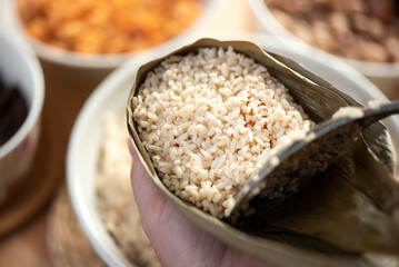 Making zongzi food - preparing and wrapping Chinese rice dumpling.