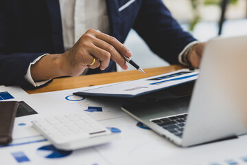 Businessman working on documents on the desk, data analysis of financial figures and business investments.