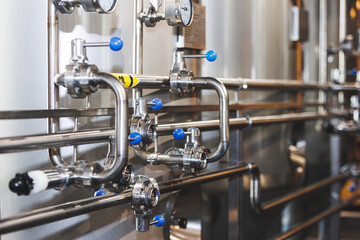 Beer brewing . Commercial brewing equipment close up shot. Industrial beer brewing stainless pipe