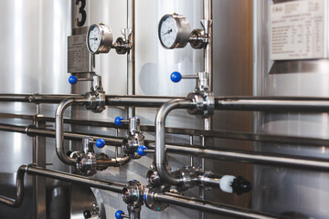 Beer brewing . Commercial brewing equipment close up shot. Industrial beer brewing stainless pipe