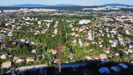 Panorama of the city and mountains in the background. View of the rusty iron tower and houses on the outskirts of Kosice. Slovakia. Europe	