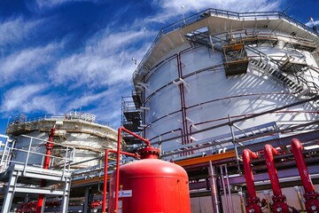 Pipelines in an industrial plant under a blue sky