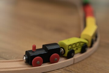 Fototapeta premium Wooden colorful toy train railway construction on the floor