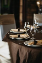 Elegant table setup in brown tablecloth