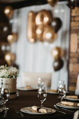 Fototapeta na wymiar Vertical shot of a festive table and 18 birthday decoration with golden anniversary balloons