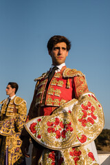 Serious matador standing near friend