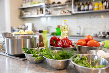 Fresh Vegetables lie in a metal bowls: tomatoes, asparagus, cucumbers, green. Fresh Vegetables lie in a metal bowls: tomatoes, asparagus, cucumbers, green.