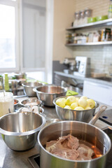 pan on the stove with meat in kitchen interior home