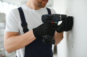 drywall worker works on building site in a house.