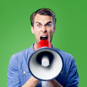 Yelling man shouting through mega phone, loudspeaker, advertising sales offer, rebates deals, isolated bright green background. Male person in casual cloth making announcement, studio concept. Square