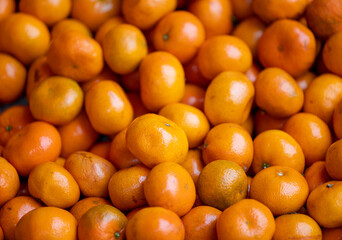 Heap of ripe orange fruit in market
