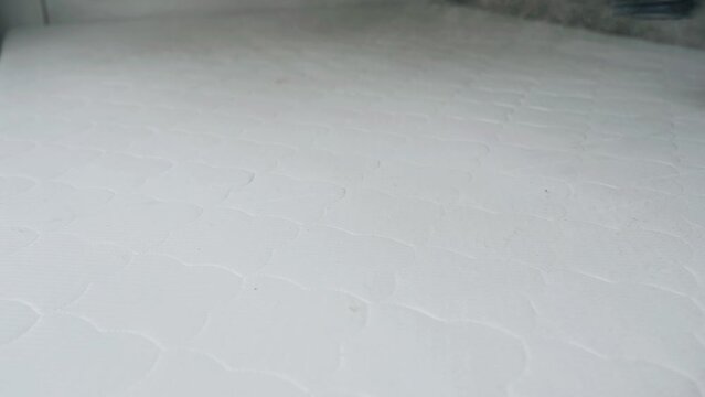 Close-up. Cleaning the mattress with a steam cleaner. Heat treatment and cleaning from dirt and insects of bedding.