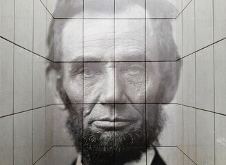 Close-up of a recurring image of Abraham Lincoln on white tile. Double exposure conceptual image of the greatest president in American history.
