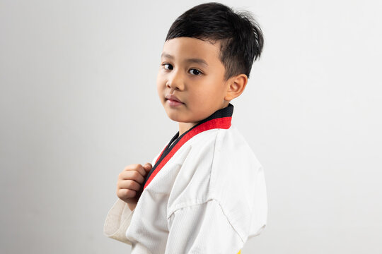 Portrait Asian boy kid karate martial arts. Taekwondo uniform with yellow belt. Asian school boy isolated on white background banner