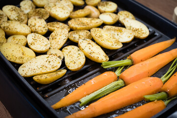 Carrot and sweet potato on the grill. Roasted root vegetable top view closeup