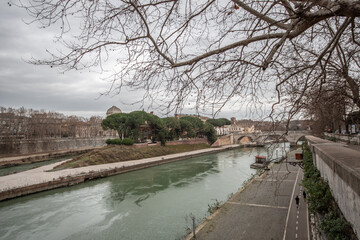 Fototapeta na wymiar Rome, Tiber river with view of Tiber Island on a cloudy day