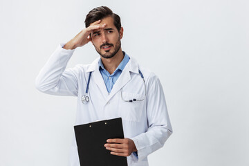 Man doctor in white coat with stethoscope and record folder and patient chart unhappy angry on white isolated background, copy space, space for text, health