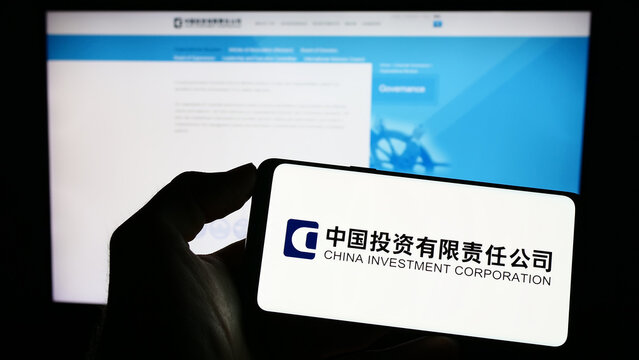 Stuttgart, Germany - 04-02-2023: Person holding cellphone with logo of China Investment Corporation (CIC) on screen in front of webpage. Focus on phone display.