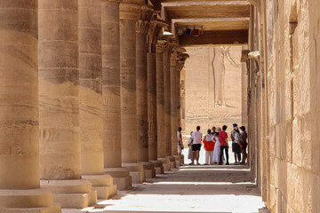 A group of tourists listening to tour guide at Philae temple in Aswan, Egypt 