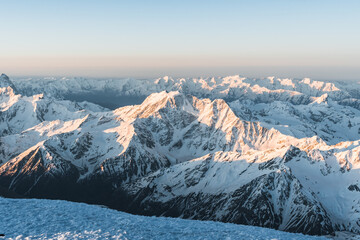 Snowy mountains at sunrise. Beautiful landscape with snowy rocks