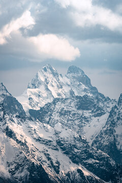 View of  Mount Ushba and snow-covered peaks on a cloudy day