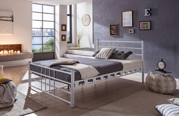 interior of a bedroom , metal white bed , mattress with bed base.