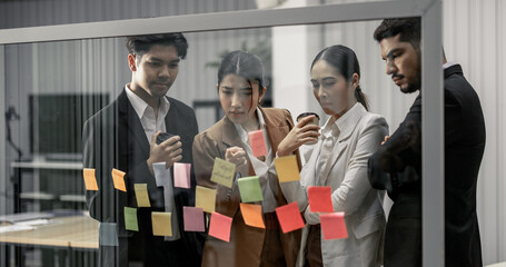 Businessperson discuss, exchange ideas and develop fresh perspectives by using sticky notes....