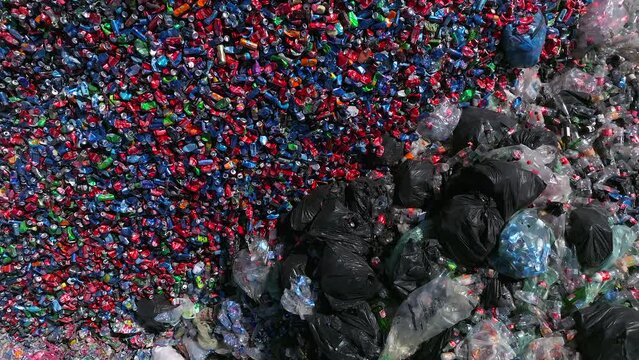 Plastic bottles and Trash Soda cans recycling piles in a local facility