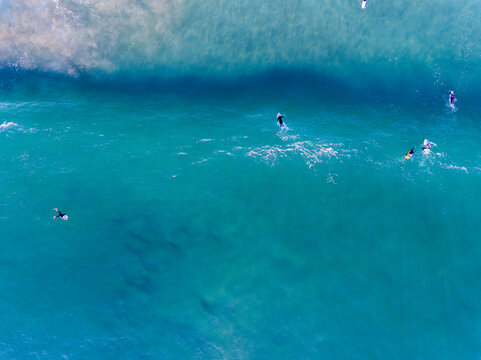 Caparica Beach Aerial Photos of surfist in sea, Portugal