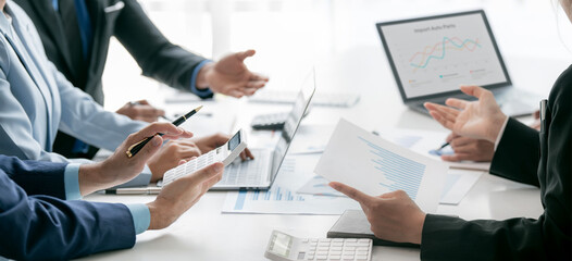 Group of young people working together. Creative business people analyzing business growth graph in modern office