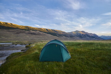 Hiking in the mountains. Rivers and mountain lakes, summer landscape of ridges and peaks. An amazing journey