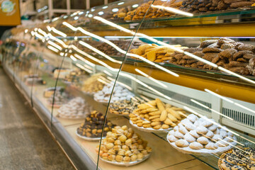 Oriental sweets in the supermarket. The counter with oriental sweets
