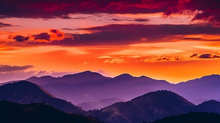A colorful sunset over a mountain range, with the sky painted in shades of orange, red, and purple.