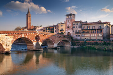 Naklejka premium Verona, Italy. Cityscape image of beautiful Italian town Verona with the Stone Bridge over Adige River at sunset.