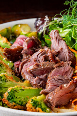 Roast beef salad with vegetables on plate