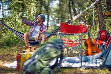 camping, tourism and travel concept - man  have good time on camping trip.