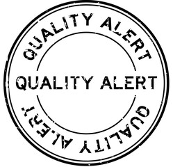 Grunge black quality alert word round rubber seal stamp on white background