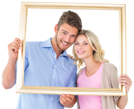 Attractive young couple holding picture frame